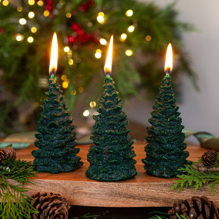Pintail Candles - Christmas Tree Forest Christmas Tree Candle on display with glowing flames and festive scents.
