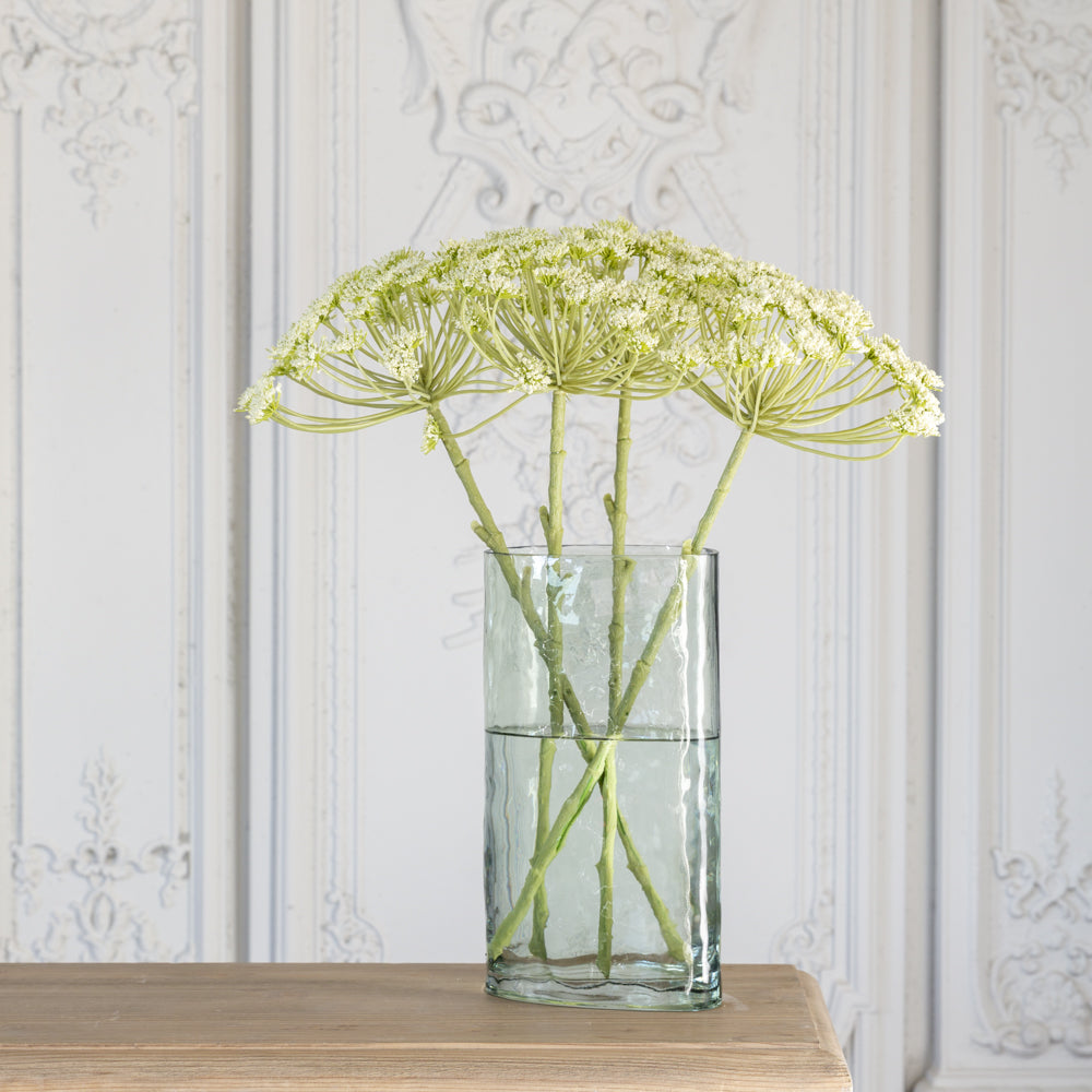 tall green glass vase with long stemmed flowers