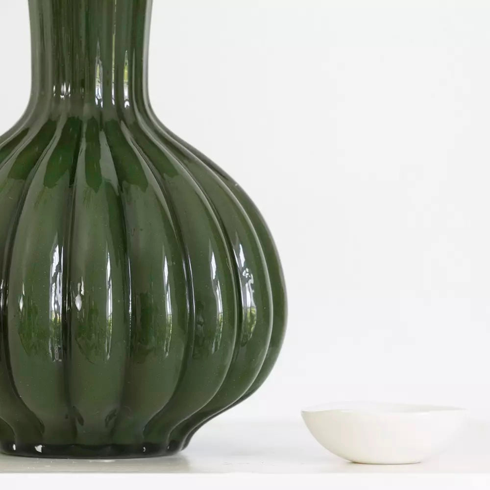 Olive Green Glass Vase with Frill Rim - Harper next to a small white dish.