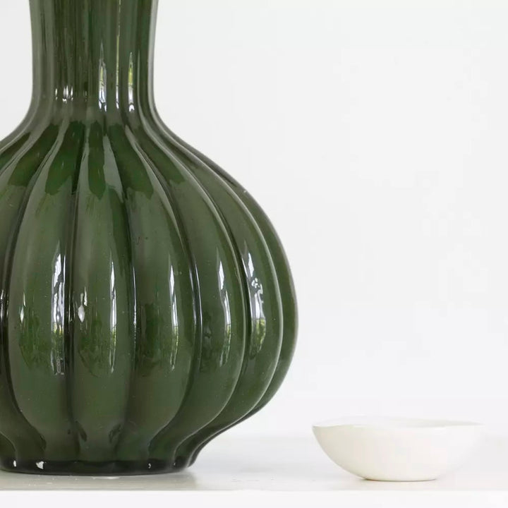 Olive Green Glass Vase with Frill Rim - Harper next to a small white dish.