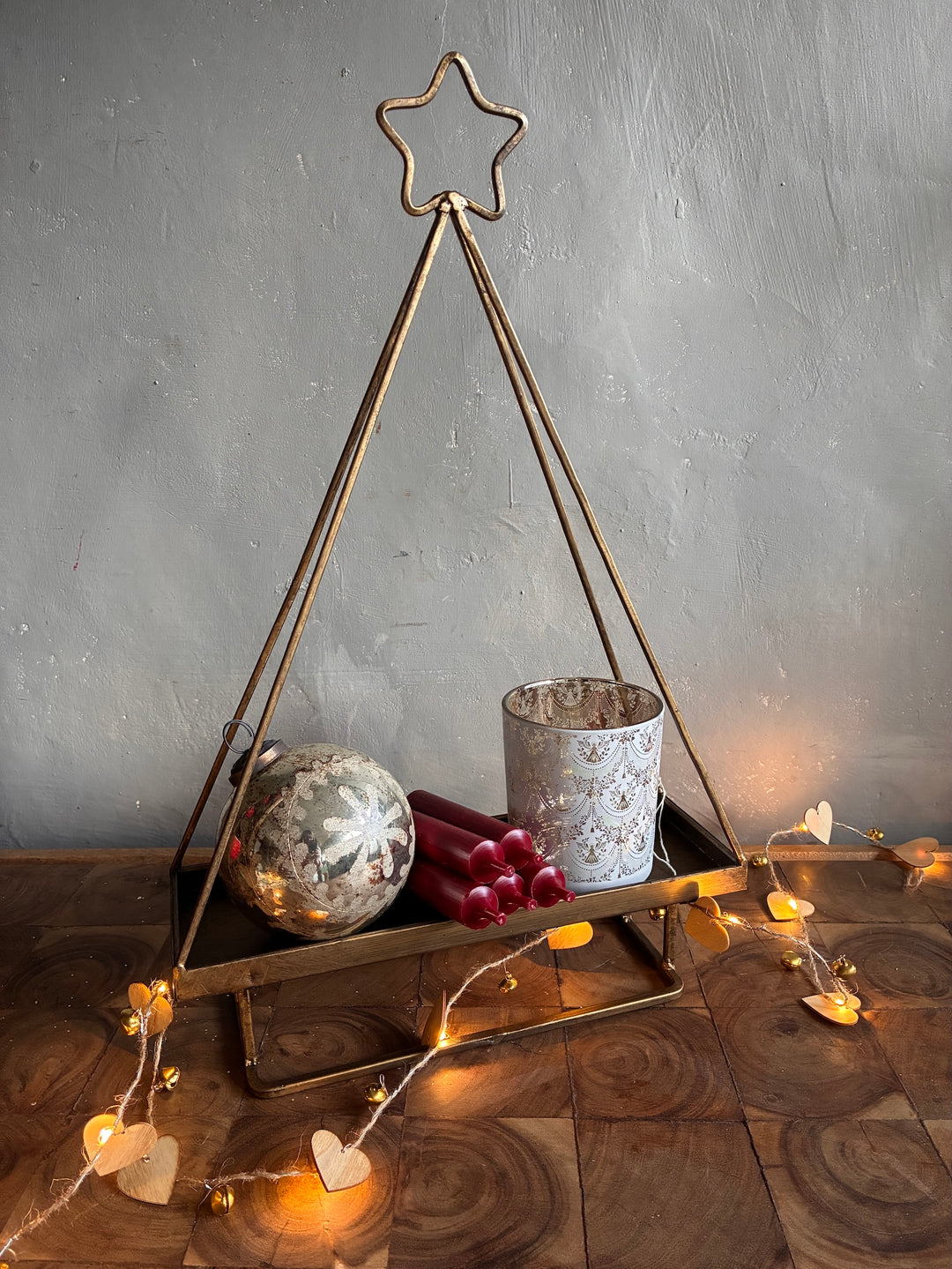 Star Topped Gold Metal Christmas Tree Tray displaying candles and ornaments for festive decor by Source for the Goose Devon.