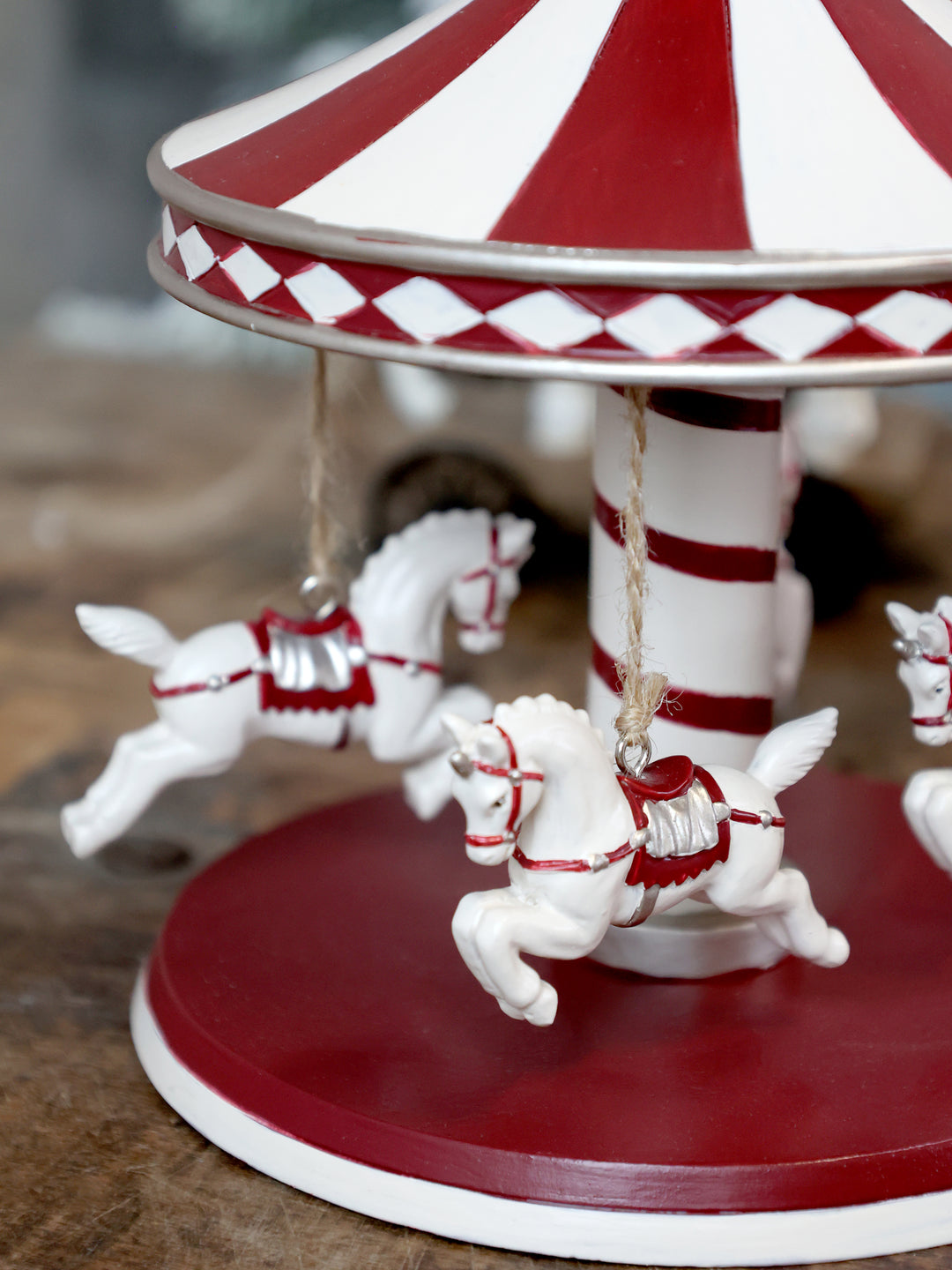 red and white horses on small decorative carousel