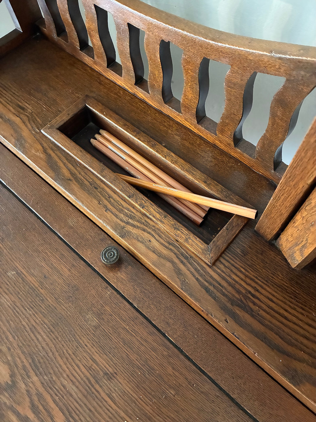 Close-up of the Edwardian Lady's Writing Desk showing a drawer with wooden writing tools, highlighting its charming craftsmanship.