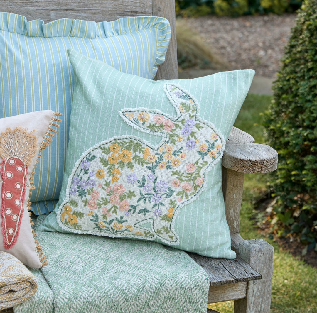 Charming Embroidered Bunny Cushion featuring a floral rabbit design against a blue striped background.