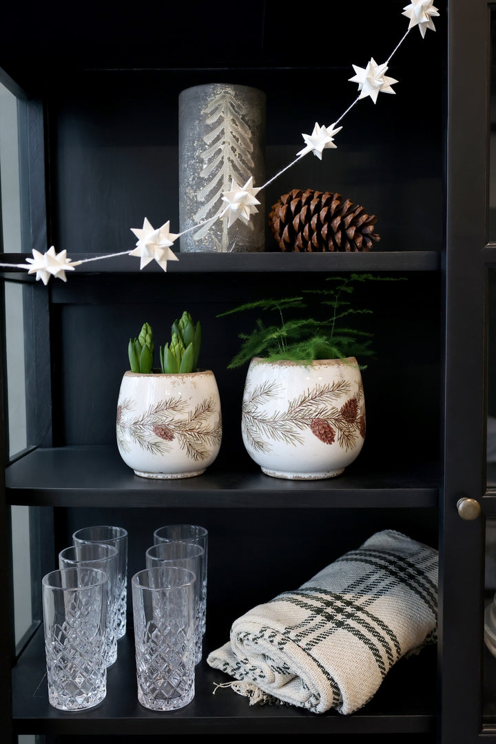 Fir Cone Decorative Planter with plants on shelf, featuring cozy autumn decor by Source for the Goose, Devon.