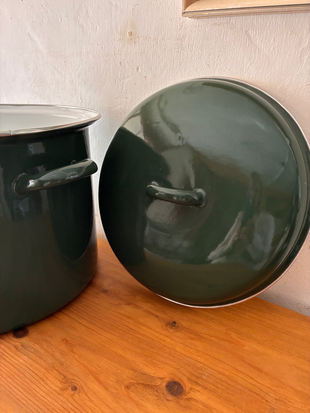 Vintage Green Enamel Bread Bin with matching lid on a wooden table, ideal for rustic country cottage kitchen decor.