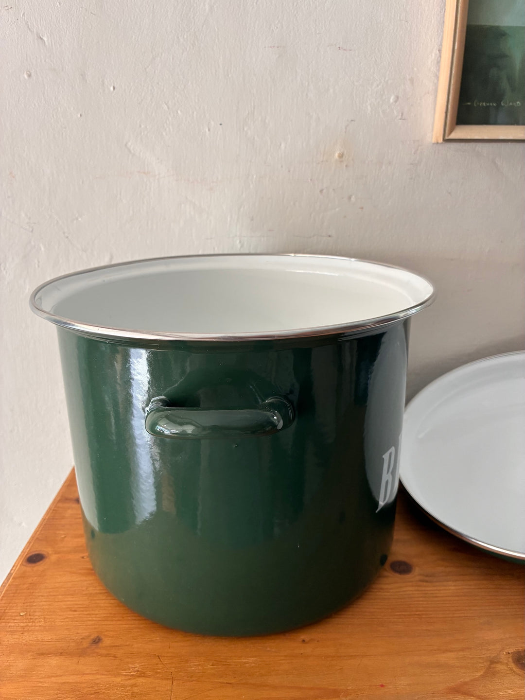 Vintage Green Enamel Bread Bin on a wooden table with a white interior and rustic handles.