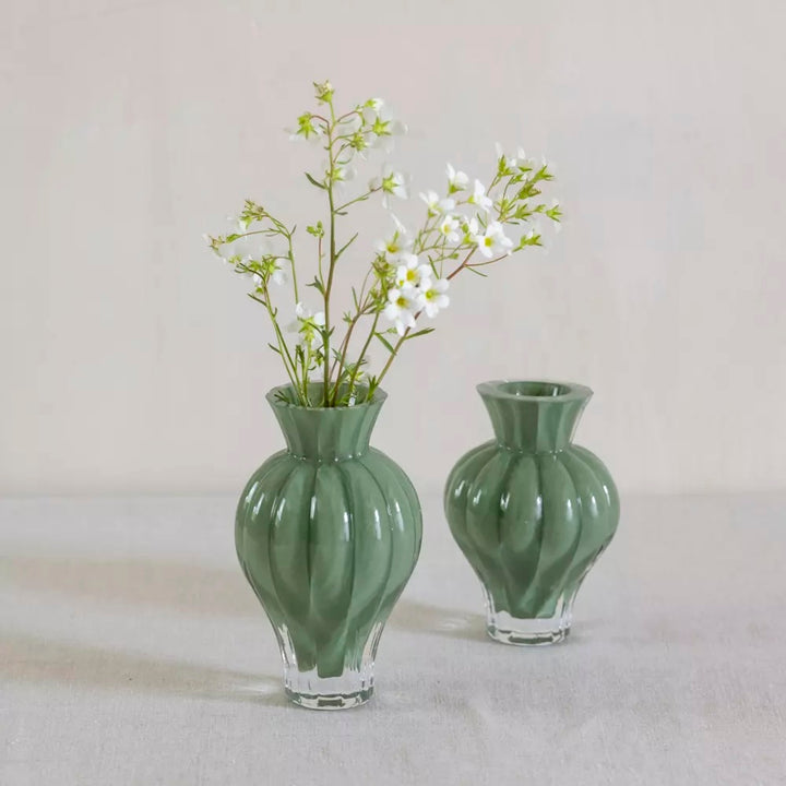 Soft Green Ribbed Glass Bud Vase featuring delicate white flowers in an elegant display.