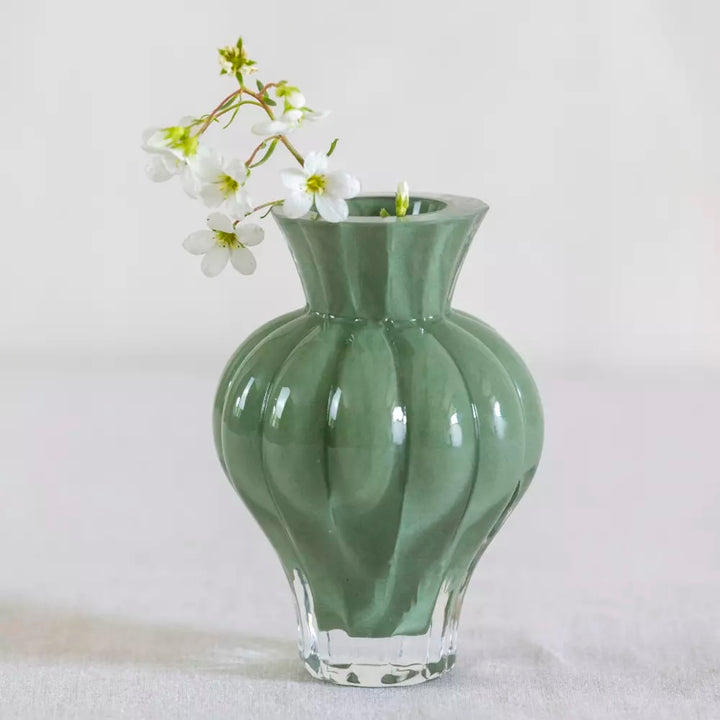 Soft Green Ribbed Glass Bud Vase with white flowers, showcasing elegance and sophistication for home decor.