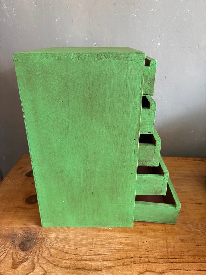Vintage Green Mini Set of Drawers on a wooden table, showcasing five spacious drawers with an aged finish.