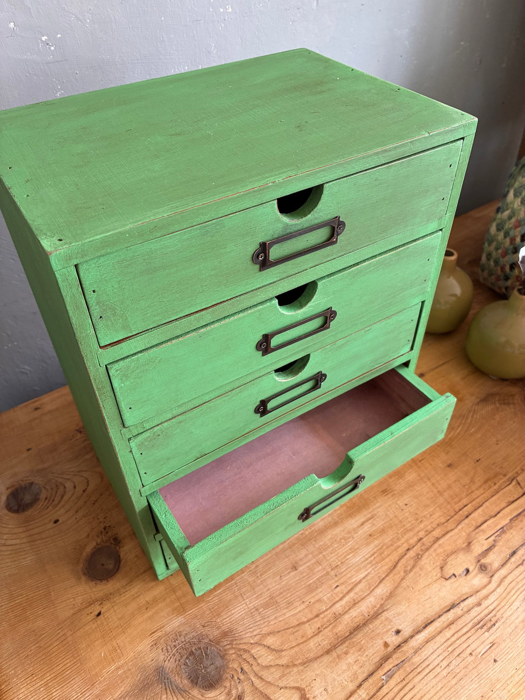 Vintage Green Mini Set of Drawers on a wood table, perfect for organizing desk essentials and adding charm.