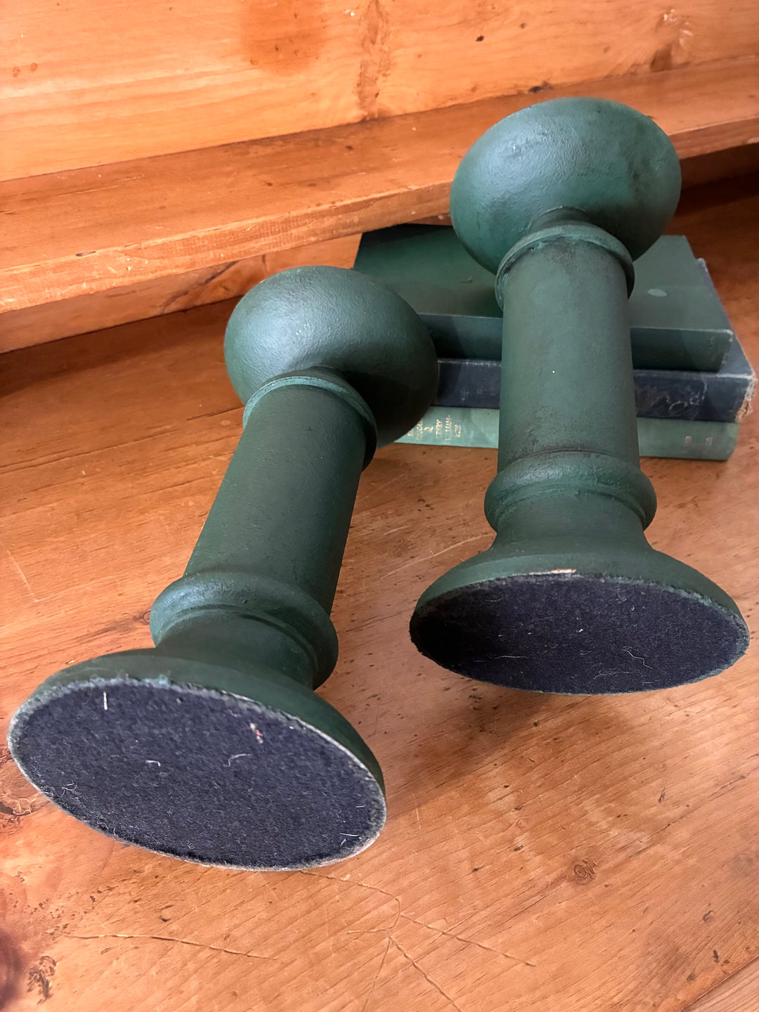 Pair of Vintage Green Metal Candlesticks on wooden surface with black felt bases, showcasing vintage home decor.
