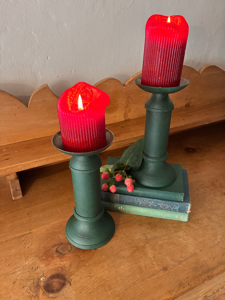 Pair of Vintage Green Metal Candlesticks with red candles on a wooden table, enhancing vintage home decor.