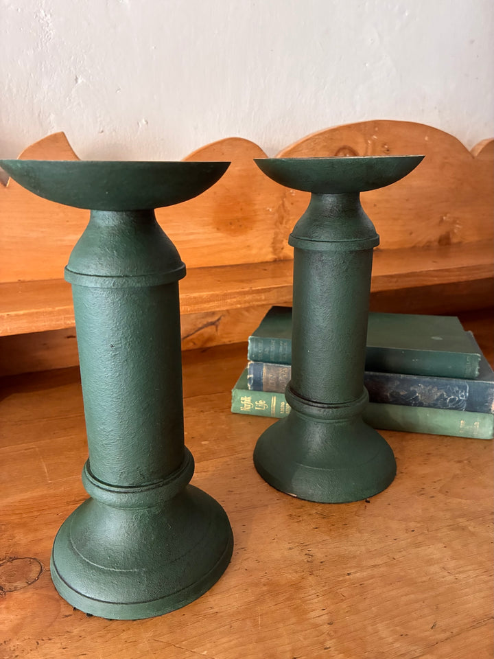 Pair of Vintage Green Metal Candlesticks on a wooden table beside vintage books.