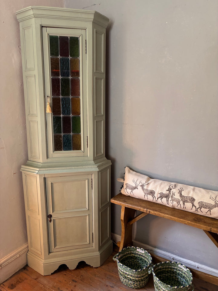 Green Painted Corner Cupboard with Stained Glass Panel in a vintage home setting, showcasing cottage core decor.