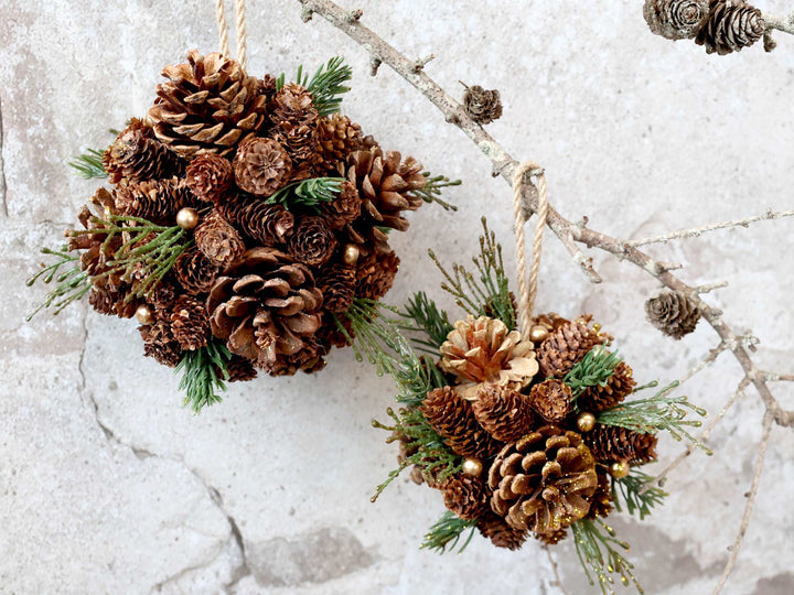 hanging ball made with pine cones, faux greenery and glitter