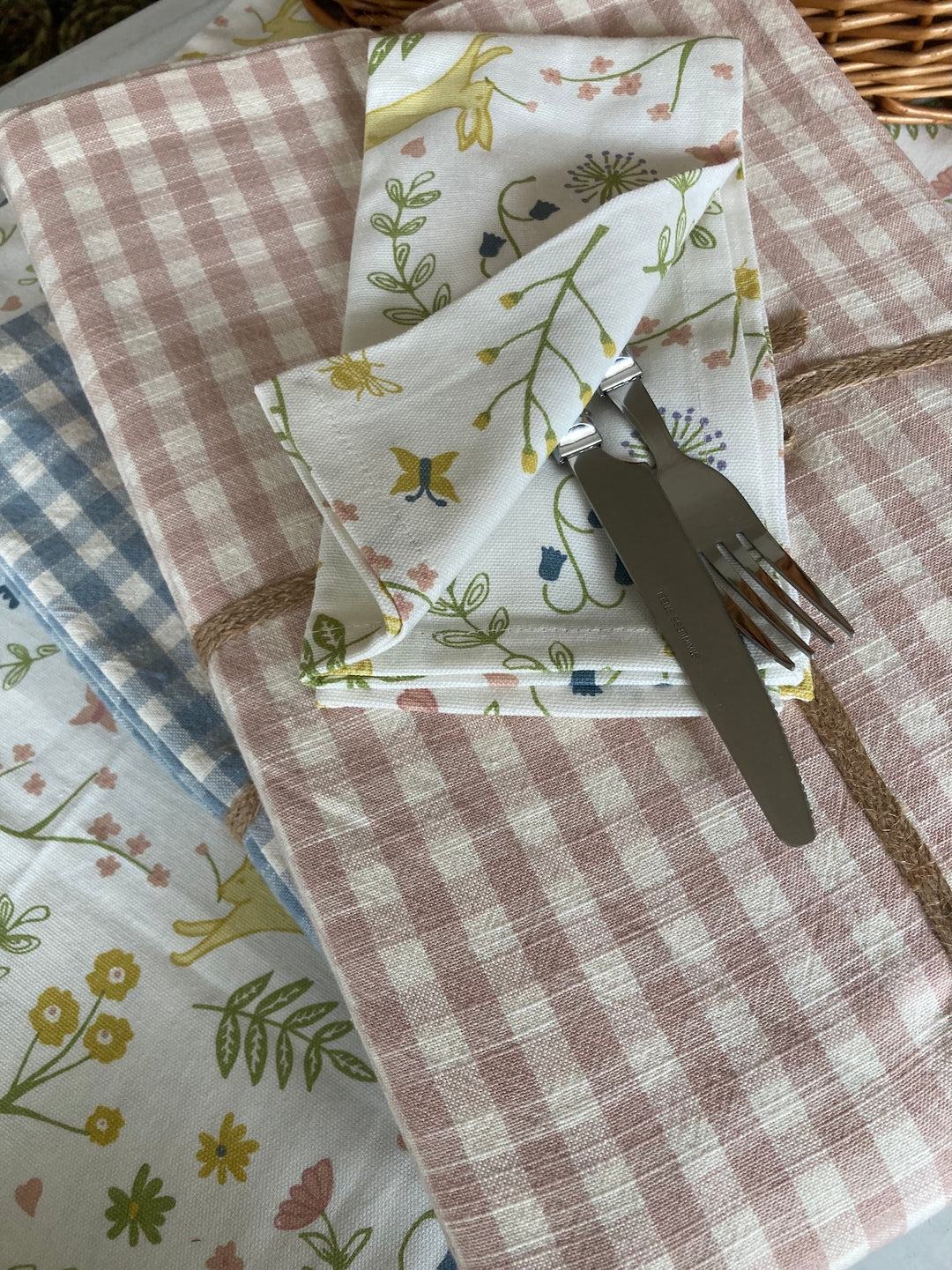 Set of Four Hares and Meadow Napkins from Source for the Goose, featuring pastel colors and floral designs, ideal for summer dining.