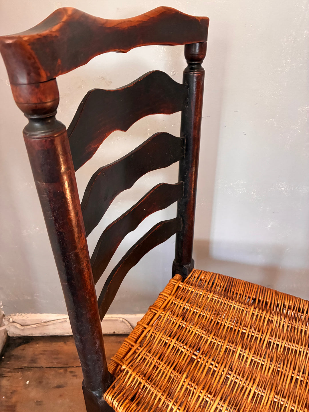 Antique Ladderback Chair - Lancashire showcasing curved top rail and hand-woven rush seat.