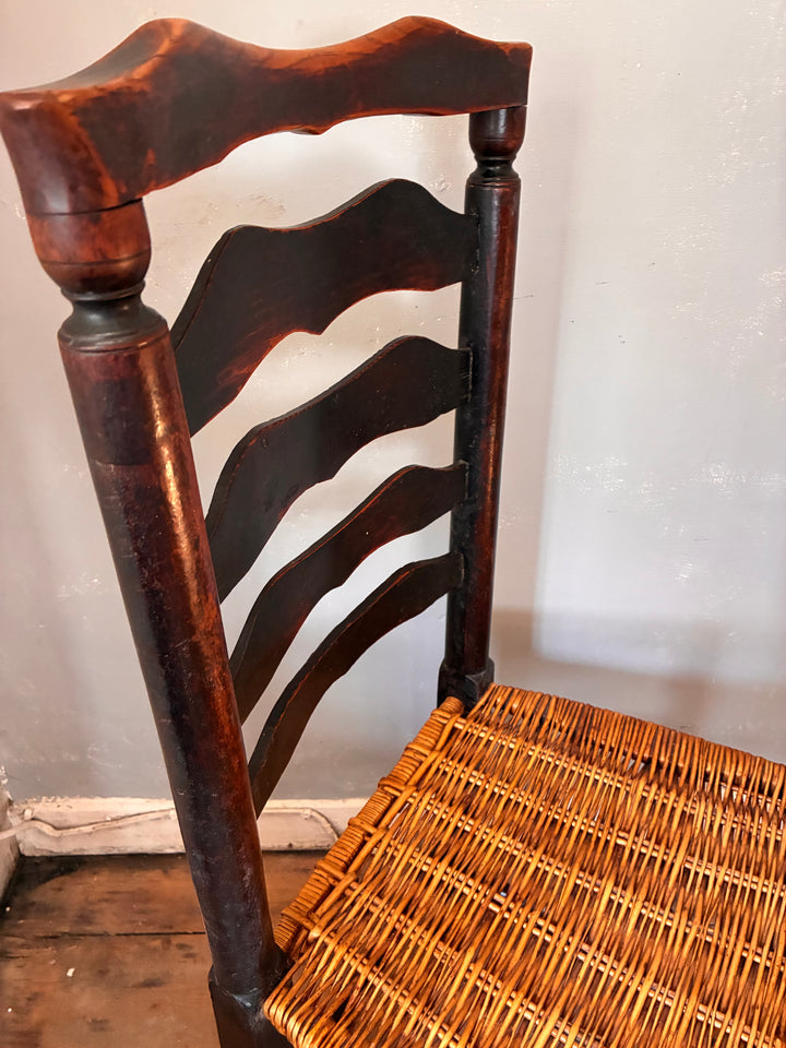 Antique Ladderback Chair - Lancashire showcasing curved top rail and hand-woven rush seat.