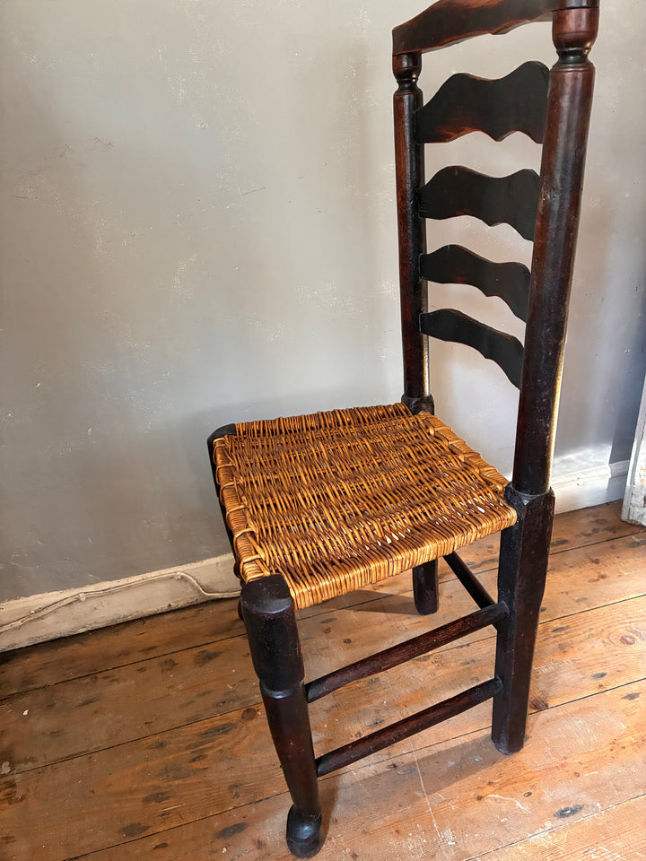 Antique Ladderback Chair - Lancashire with a hand-woven rush seat and curved ladder slats showcasing classic design.