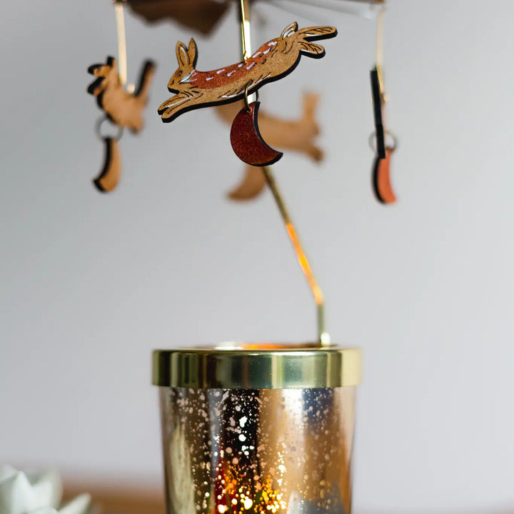 Hare Candle Carousel by Lily Faith – Spinning Christmas Tealight Holder with laser-cut designs above a gold tealight holder.