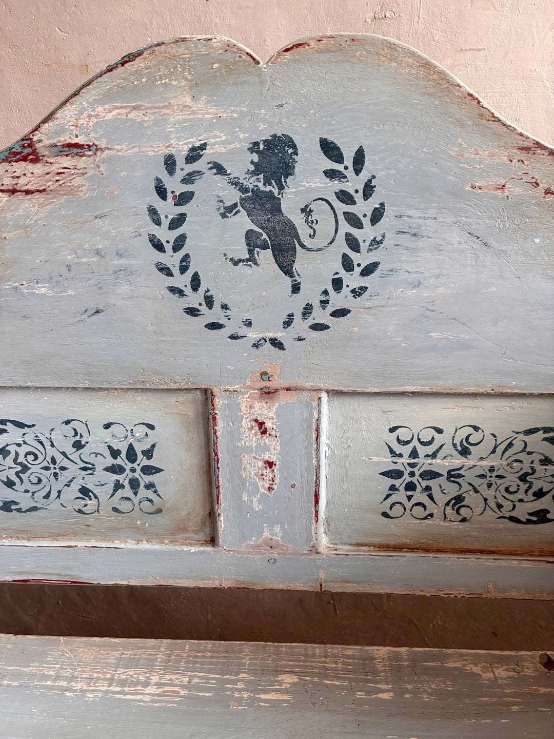 Vintage Long Painted Hungarian Bench with distressed blue paint and decorative lion emblem.