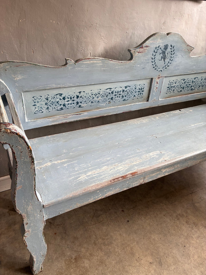 Vintage Long Painted Hungarian Bench showcasing distressed blue paint and floral carvings, a unique decor piece from Source for the Goose Devon.