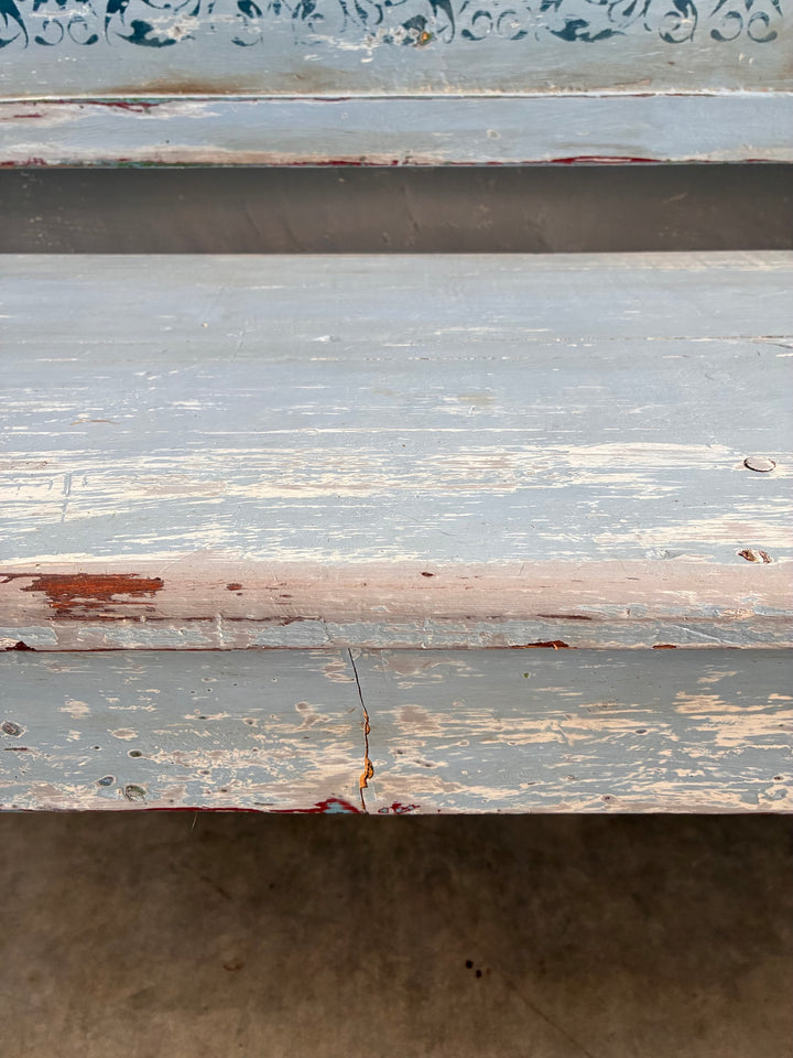 Close-up of Vintage Long Painted Hungarian Bench showcasing its distressed blue surface and colorful paint layers.