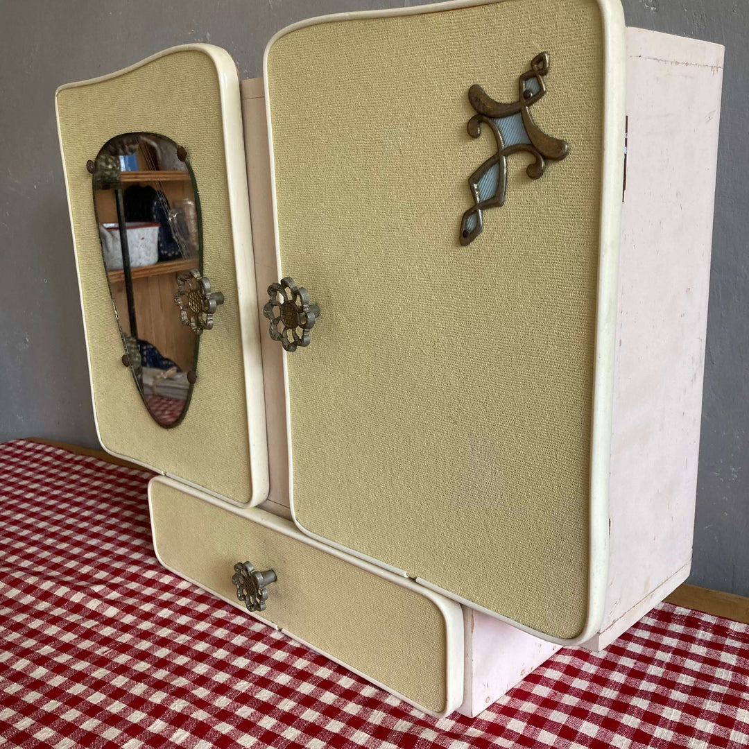 Mid Century French Wall Cabinet with filigree handles and pear-shaped mirror, Source for the Goose Devon, on plaid tablecloth.