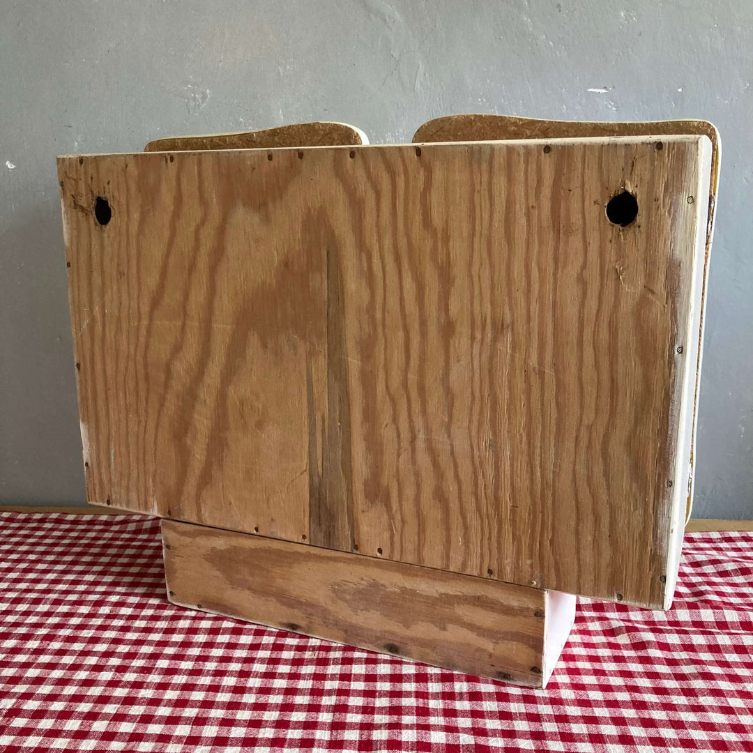 Rear view of a Mid Century French Wall Cabinet showing wood grain texture on a checkered tablecloth from Source for the Goose, Devon.