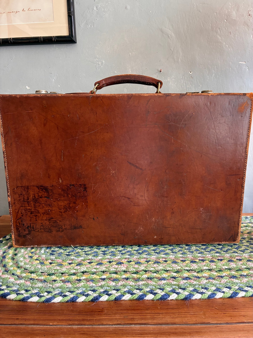 Vintage leather suitcase back view, showcasing rich patina and sturdy construction from Source for the Goose, Devon.