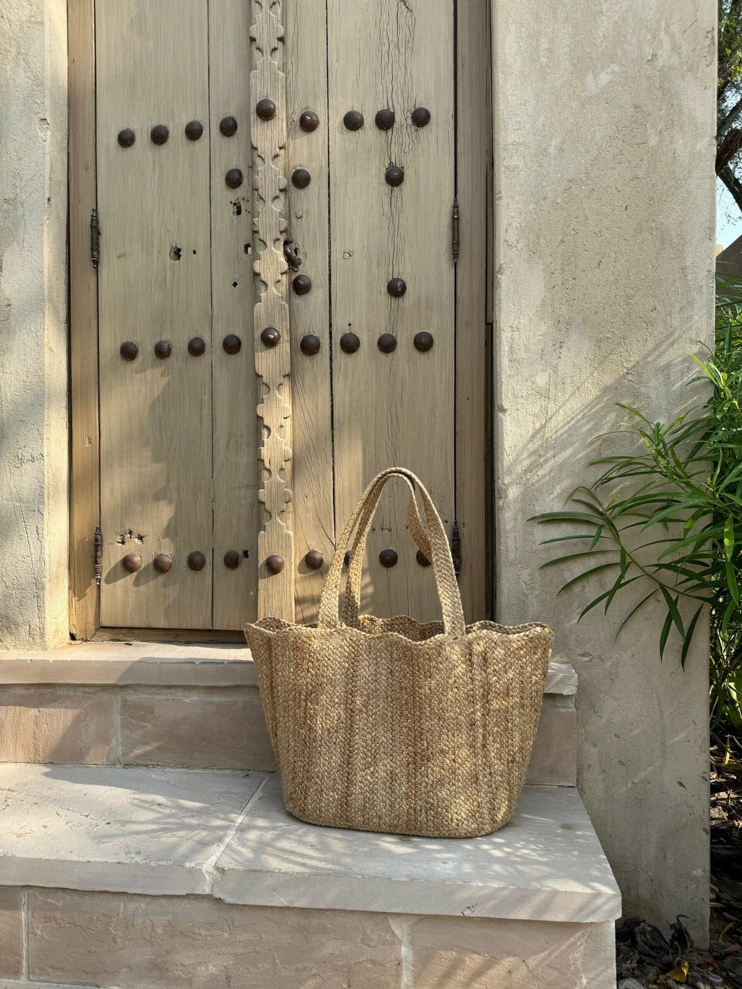 environmentally friendly jute shopper in front of an old door