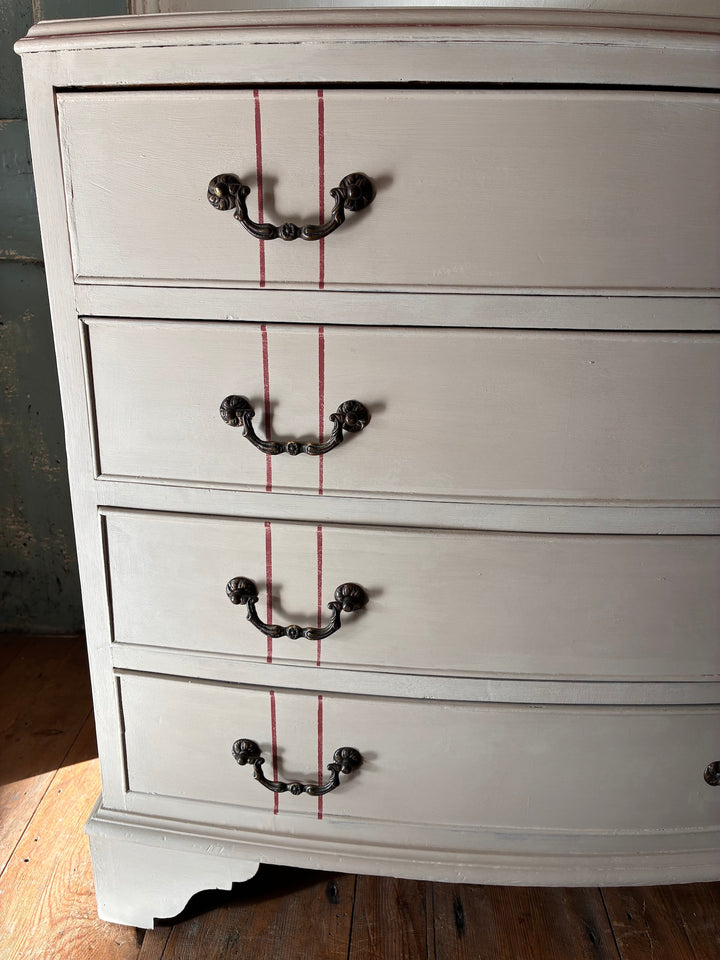 The Georgian Ribbon Chest of Drawers- Hand Painted with soft primer red stripes and antique handles in a vintage home setting.