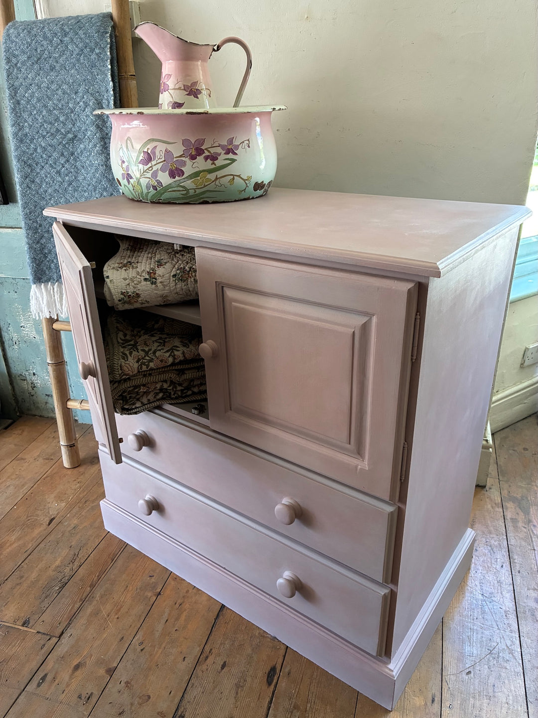 Pretty painted cupboard with drawers in heather tones, perfect for storage and adding charm to your home. Source for the Goose, Devon.