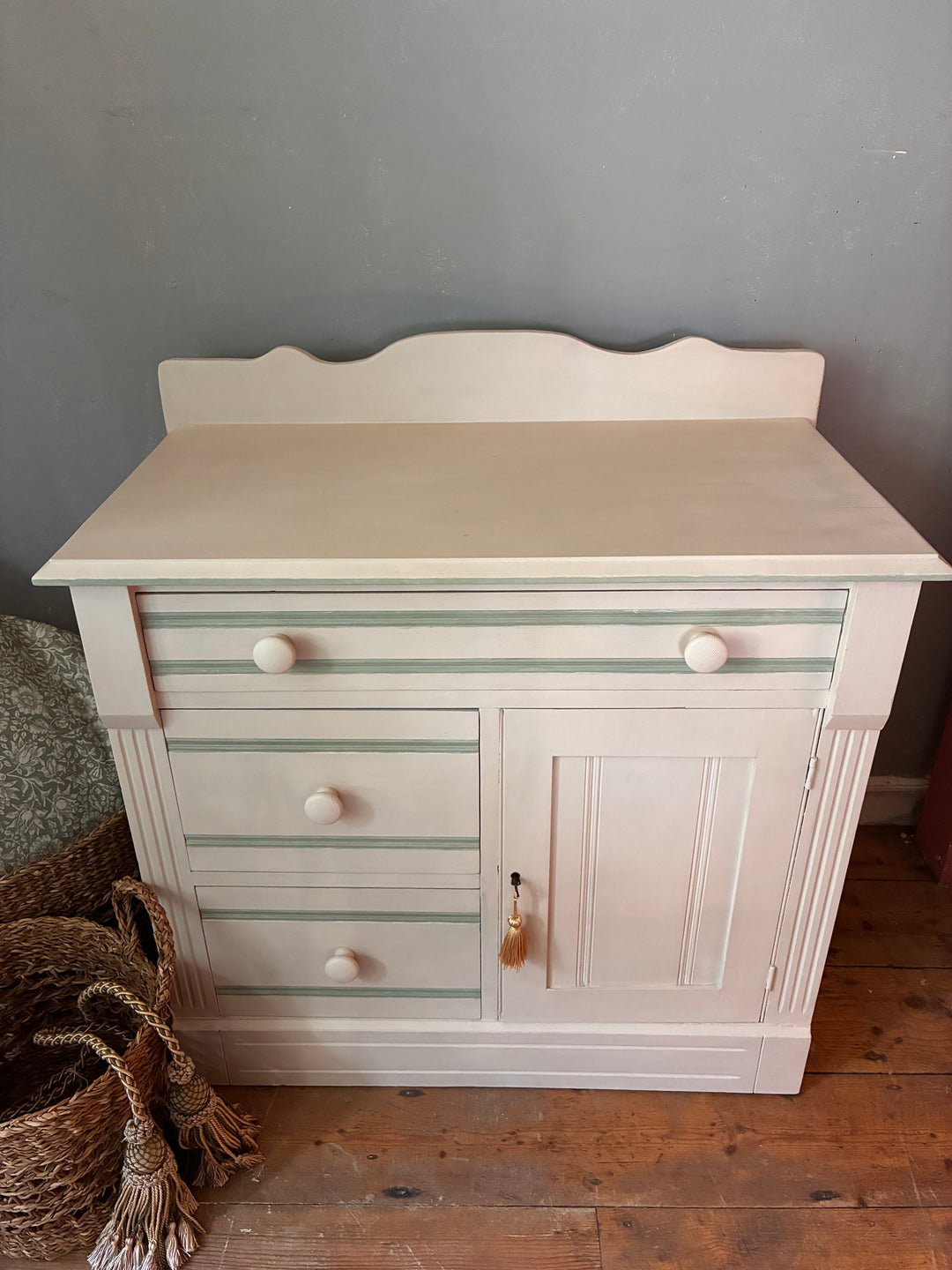 Painted Washstand Cupboard with Drawers featuring soft putty paint and striped detailing, sourced from Source for the Goose Devon.