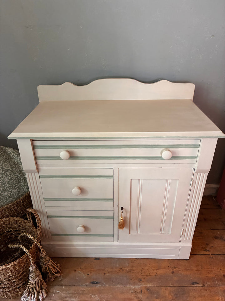 Painted Washstand Cupboard with Drawers featuring soft putty paint and striped detailing, sourced from Source for the Goose Devon.