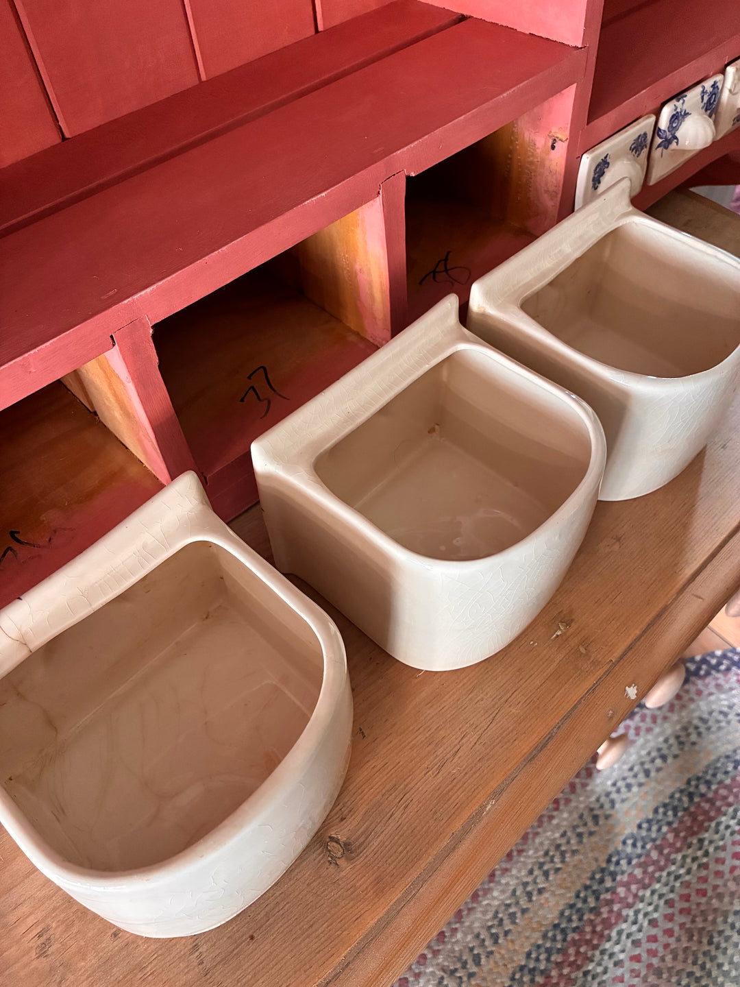 Three stylish ceramic spice drawers in soft beige, perfect for organizing herbs in a rustic kitchen decor.