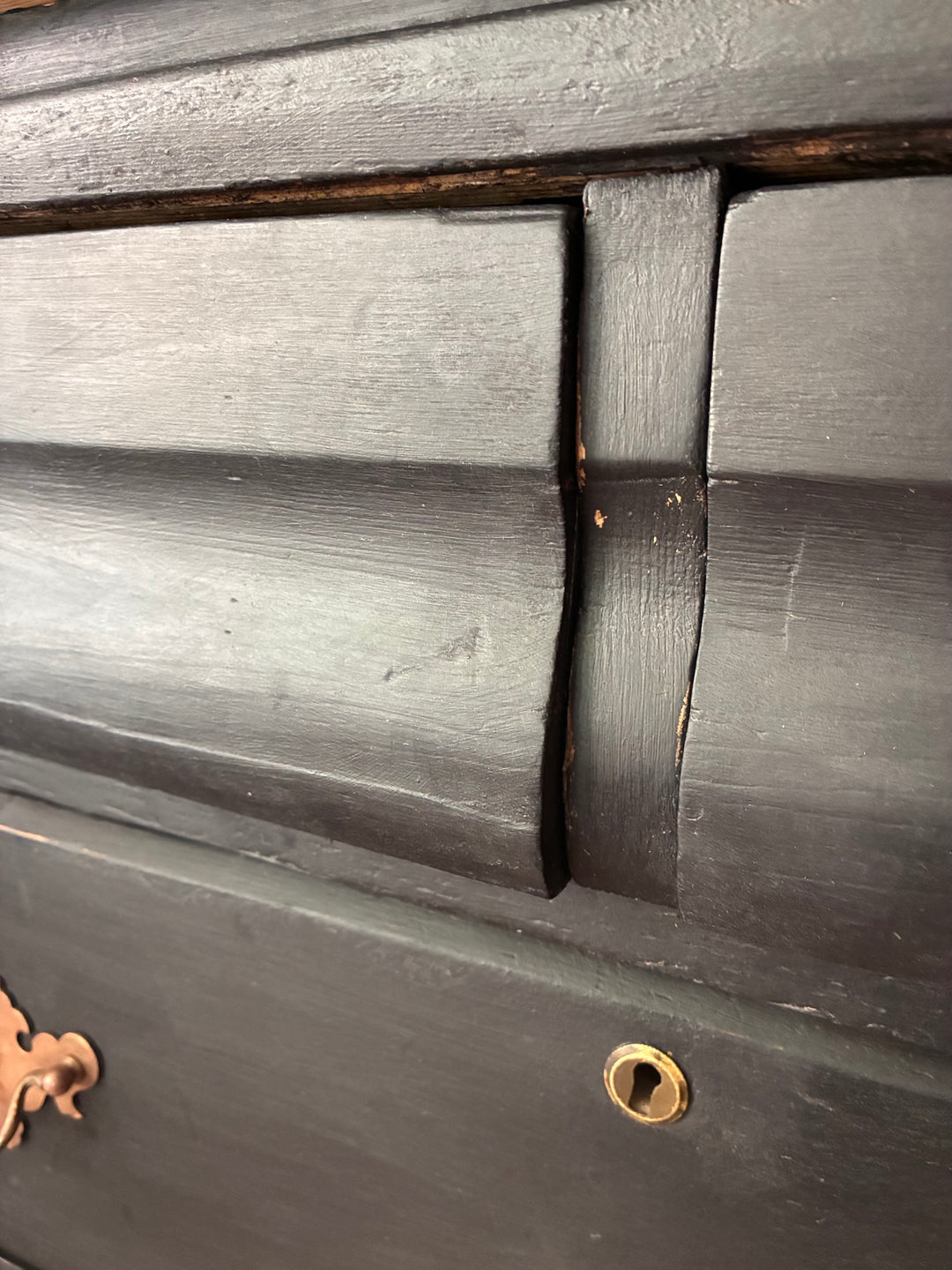 Close-up of Rustic Pine Chest of Drawers - Ebonised Paint, showcasing its detailed wood finish and brass handle.