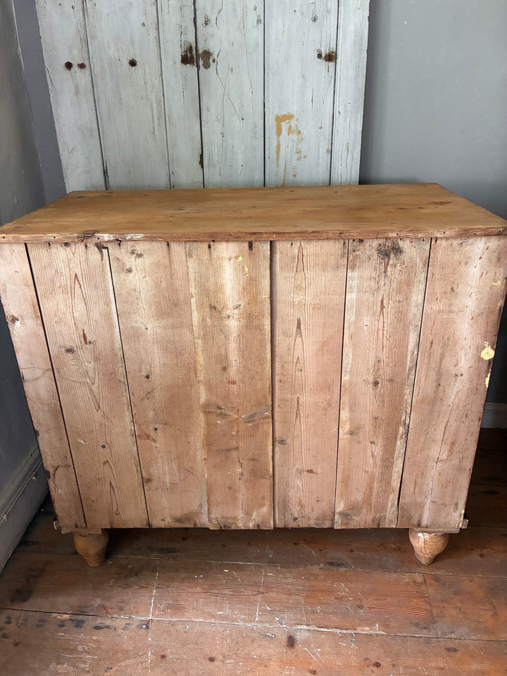 Rustic Pine Chest of Drawers - Ebonised Paint showcasing natural wood texture and character in a cozy home setting.
