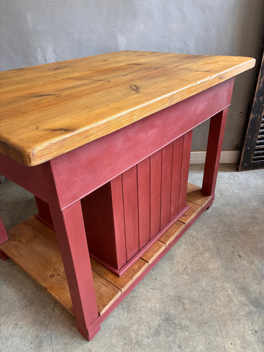 Pine Kitchen Island with Painted Base showcasing a butcher's block top and red painted base, perfect for storage and dining.