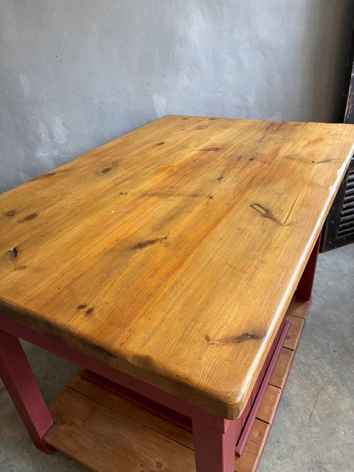 Pine Kitchen Island with Painted Base showcasing a rustic butcher's block top on a red painted base.