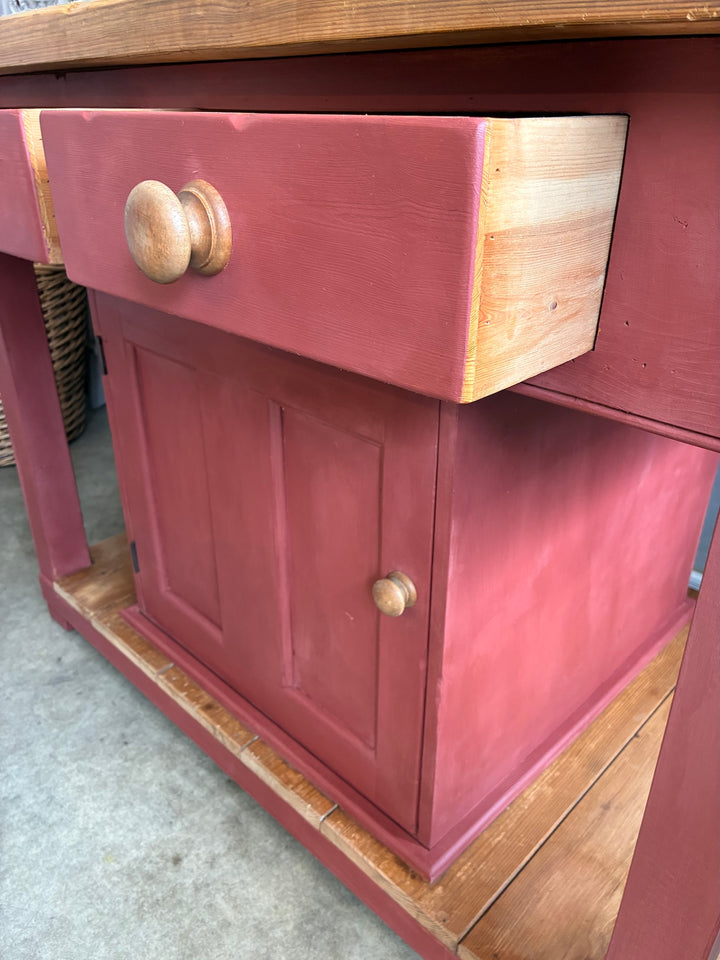 Pine Kitchen Island with Painted Base featuring a red painted drawer and central cabinet for storage.