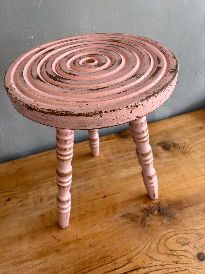 Pink Vintage French Milking Stool featuring bobbin legs and a hand-carved bullseye detail, perfect for rustic decor.