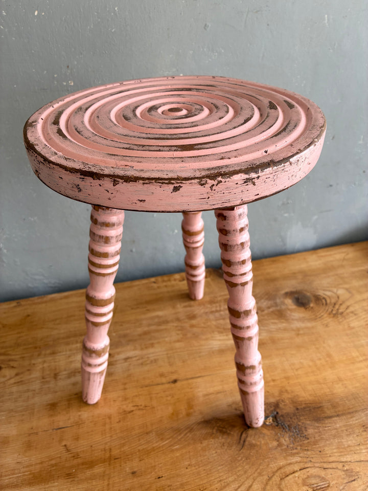 Pink Vintage French Milking Stool with bobbin legs and hand-carved detail, perfect as a decorative accent.