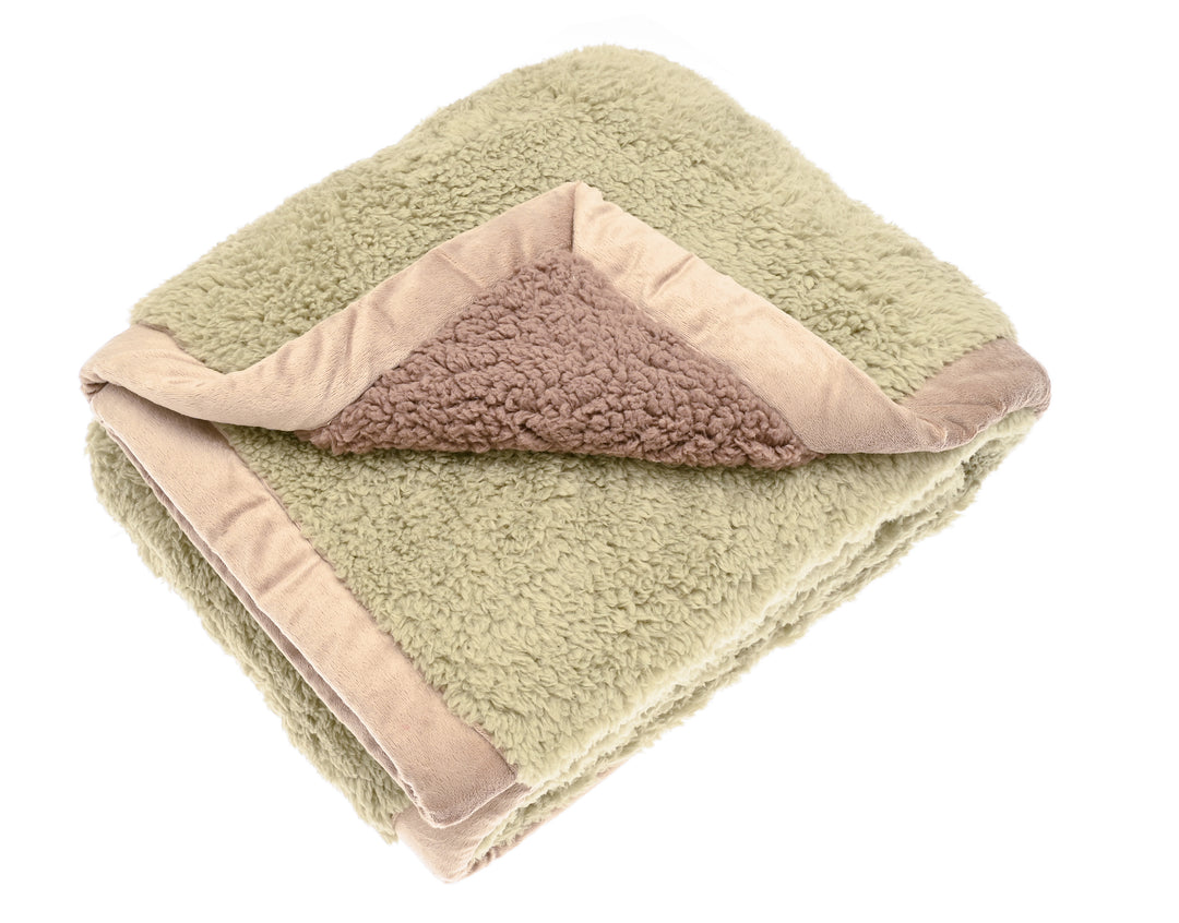 Pistachio Cosy Sherpa Throw folded, showcasing its soft green and taupe colors, perfect for cozy evenings.