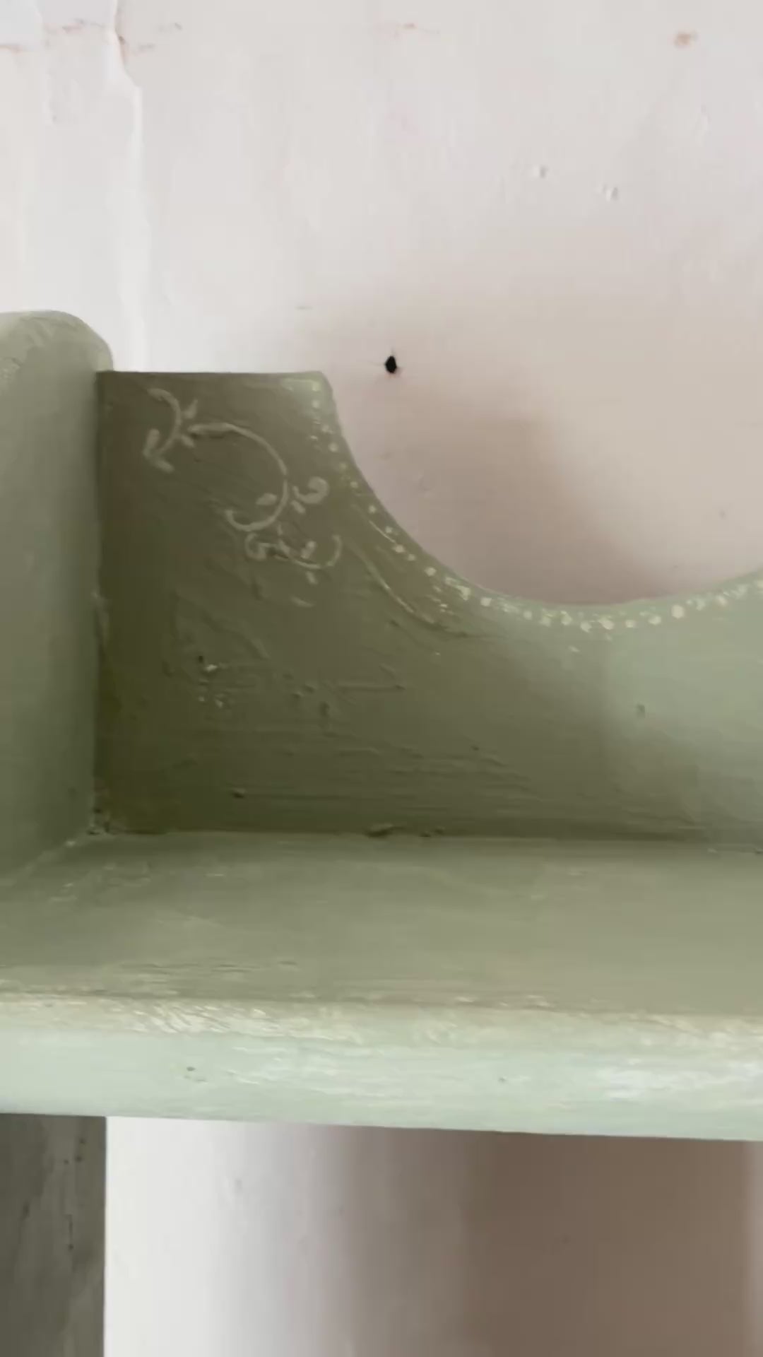 Close-up of the decorative scallop detailing on the Tall Chippy Green Bookcase from Source for the Goose Devon.