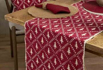 Christmas Tree Trellis Table Runner - Two Colourways in red on a wooden dining table, perfect for festive celebrations.