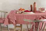 Table laid with a red and white check cotton tablecloth