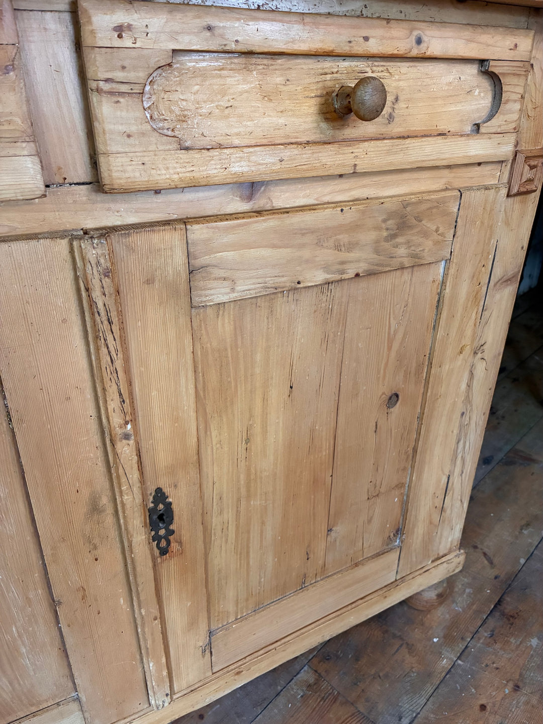 Close-up view of the Rustic Antique Pine French Cupboard showcasing its aged finish and charming wooden details.