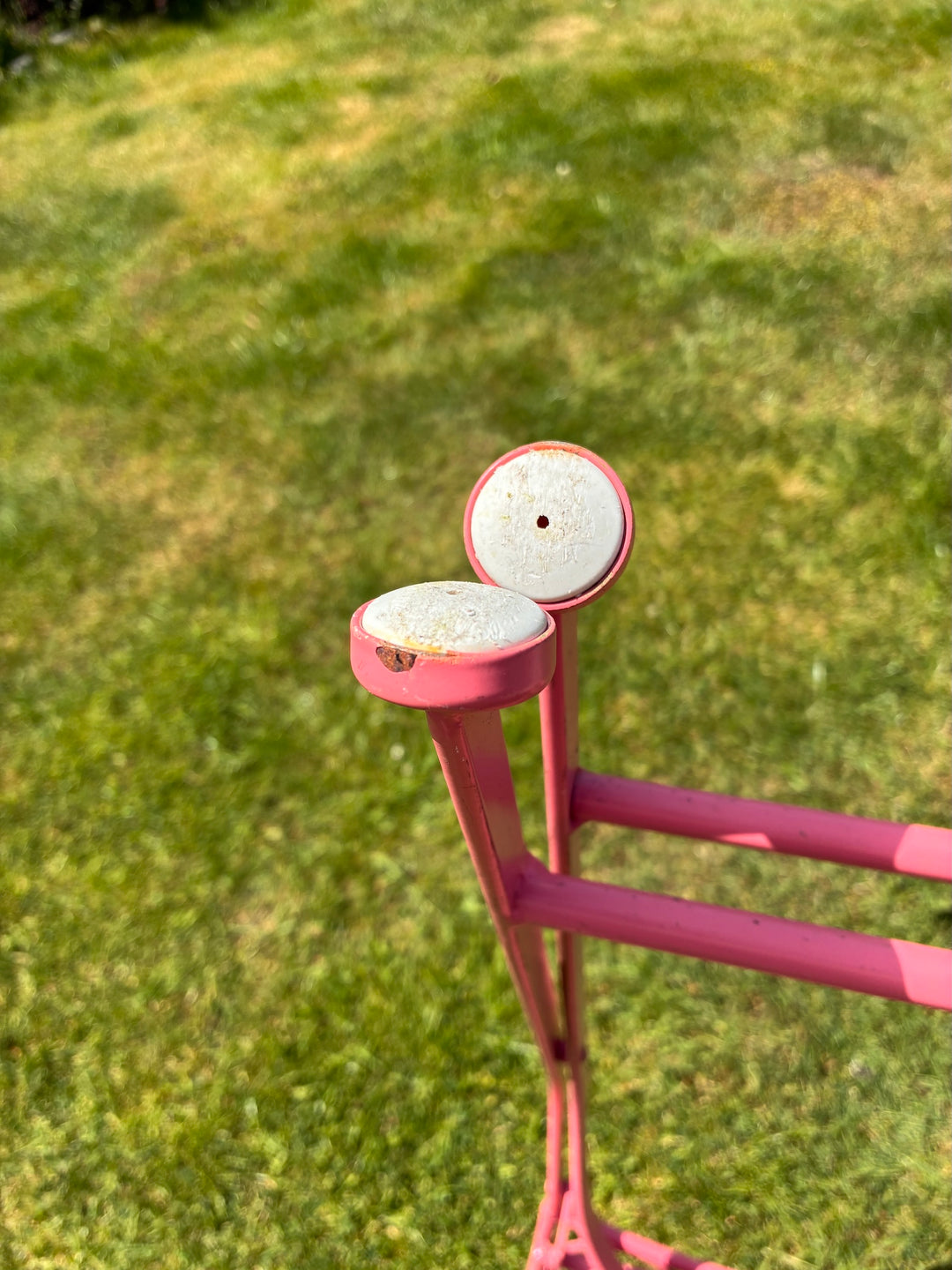 Close-up of the Avalon Rose Pink Garden Bistro Set showing the delicate latticework and antique rose pink finish.